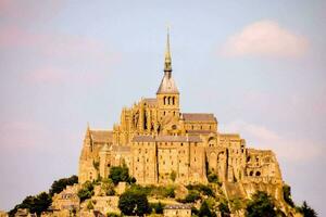 the mont saint michel is a medieval castle on a hill photo