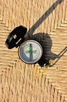 a compass on a woven surface photo