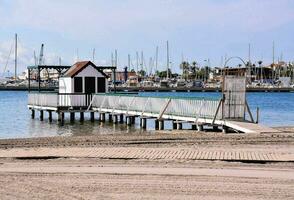 a pier with a boat dock and a small house on it photo