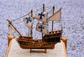 a wooden model of a ship on a wooden table photo