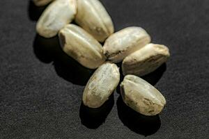 Close up of uncooked rice grains on black background. Healthy food concept. photo