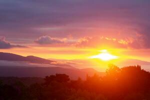 Amazing colorful sunrise over the rainforest mountains with fog and mist at Ob Luang natinoal park, Chiangmai, Thailand photo