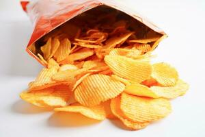 Potato chips in open bag, delicious BBQ seasoning spicy for crips, thin slice deep fried snack fast food. photo