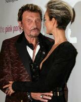 LOS ANGELES, SEP 25 - Johnny Hallyday and wife Laeticia Hallyday arrives at the Pink Party 2010 at W Hollywood Hotel on September 25, 2010 in Los Angeles, CA photo
