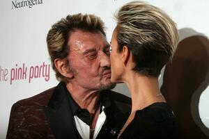 LOS ANGELES, SEP 25 - Johnny Hallyday and wife Laeticia Hallyday arrives at the Pink Party 2010 at W Hollywood Hotel on September 25, 2010 in Los Angeles, CA photo