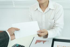 los empresarios reciben salarios o bonificaciones de la gerencia o del jefe. empresa dar recompensas para fomentar el trabajo. hombre de negocios sonriente disfrutando de una recompensa en el escritorio de la oficina. foto