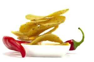 Potato chips with chili peppers on a white background. photo