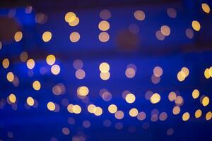 Gold spots bokeh spots on a blue background. Background for the holiday. photo