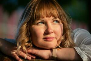 Close-up of a chubby woman in her thirties with blue eyes. photo