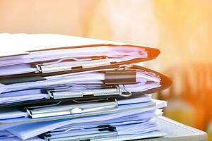 Stack of documents on table of secretary, sunlight edited, soft and selective focus. photo