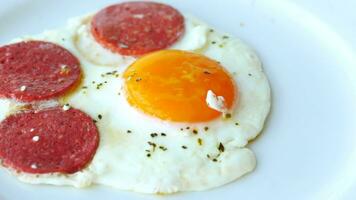 fried egg mixed with sausage on a plate video