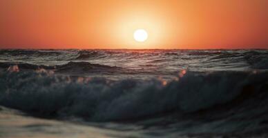 Beautiful sunset over the sea. Red sun and waves. photo