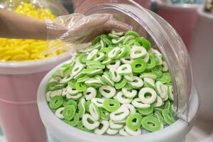 Jelly candies in containers in a store. Large selection of sweets in different colors. Sale of sweets. photo