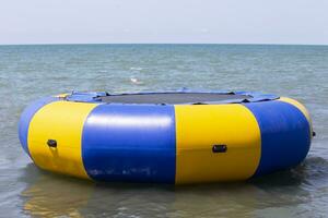 Sea trampoline in the form of a life buoy. Trampoline on the sea. photo