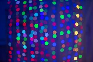 Multicolored bokeh spots on a blue background. Background for the holiday. photo