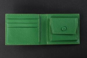 Leather products. Green leather purse on a black background. photo