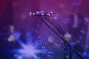 Microphones in colorful beams of stage light. photo