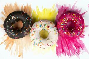 Creative sweet food. A stack of glazed colorful assorted donuts on a bright watercolor painted background. photo