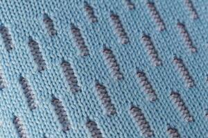 Fragment of a blue fabric sneaker. The texture of the material of sports shoes photo