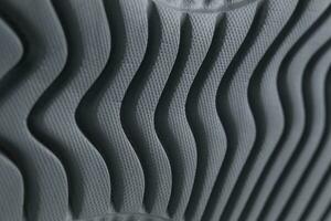 Fragment of a black sole of a sneaker. The texture of the material of sports shoes photo