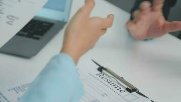 Hands of recruiter holding resume in front of candidate at desk video