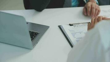 Hands of recruiter holding resume in front of candidate at desk video