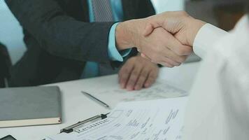 Hands of recruiter holding resume in front of candidate at desk video