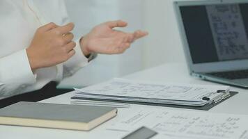 Hands of recruiter holding resume in front of candidate at desk video