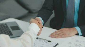 Hands of recruiter holding resume in front of candidate at desk video