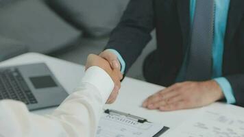 Hands of recruiter holding resume in front of candidate at desk video