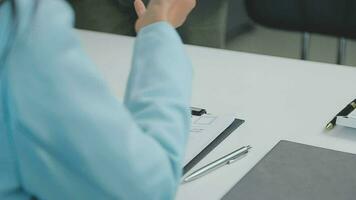 Hands of recruiter holding resume in front of candidate at desk video