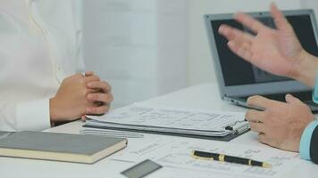 Hands of recruiter holding resume in front of candidate at desk video