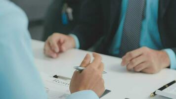 Hands of recruiter holding resume in front of candidate at desk video