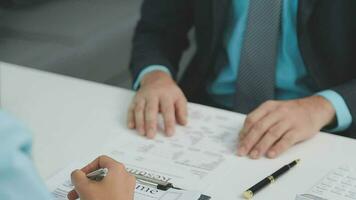 Hands of recruiter holding resume in front of candidate at desk video