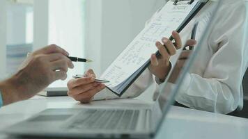 Hands of recruiter holding resume in front of candidate at desk video