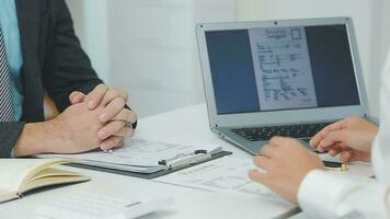 Hands of recruiter holding resume in front of candidate at desk video