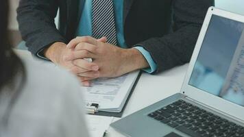 Hands of recruiter holding resume in front of candidate at desk video