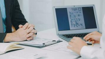 Hands of recruiter holding resume in front of candidate at desk video