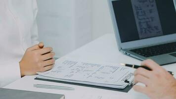 Hands of recruiter holding resume in front of candidate at desk video