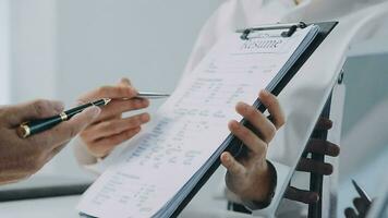 Hands of recruiter holding resume in front of candidate at desk video