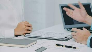 Hands of recruiter holding resume in front of candidate at desk video