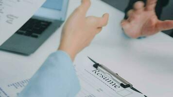 Hands of recruiter holding resume in front of candidate at desk video