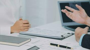 Hands of recruiter holding resume in front of candidate at desk video