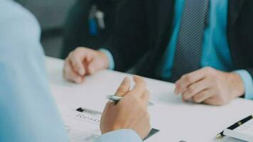 Hands of recruiter holding resume in front of candidate at desk video