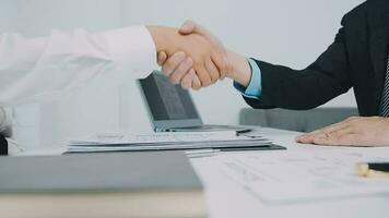 Hands of recruiter holding resume in front of candidate at desk video