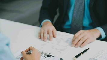 Hands of recruiter holding resume in front of candidate at desk video