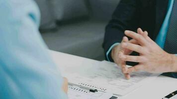 Hands of recruiter holding resume in front of candidate at desk video