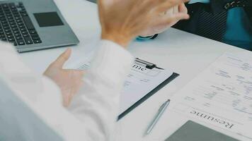 Hands of recruiter holding resume in front of candidate at desk video