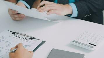 Hands of recruiter holding resume in front of candidate at desk video