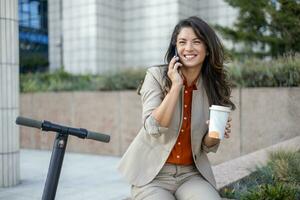 Beautiful woman riding an electric scooter to work, modern senior women l, new generation, electric transport, ecology, ecological transport,electric skateboard, photo